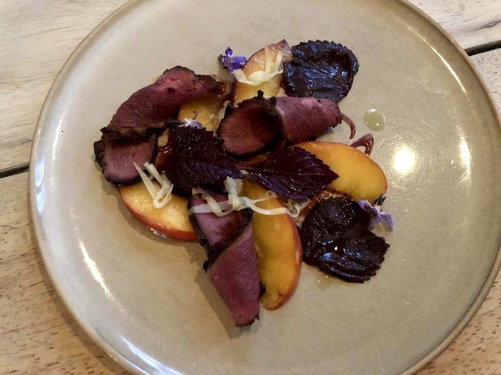 Duck tataki with peaches and shiso leaves.
