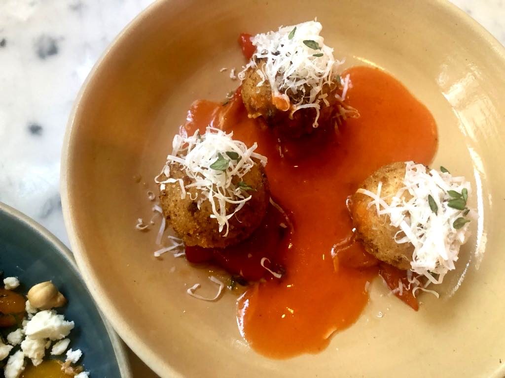 Ricotta balls with red-pepper sauce.