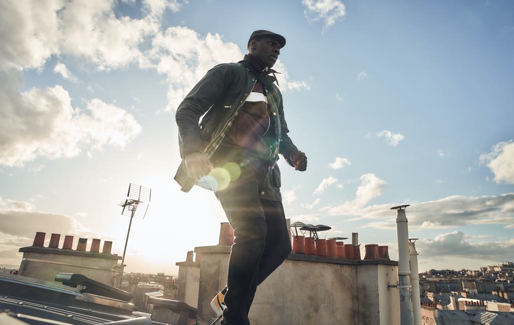 Assane Diop (Omar Sy), the latter-day Arsène Lupin, escapes over the rooftops of Paris. Photo: Emmanuel Guimier