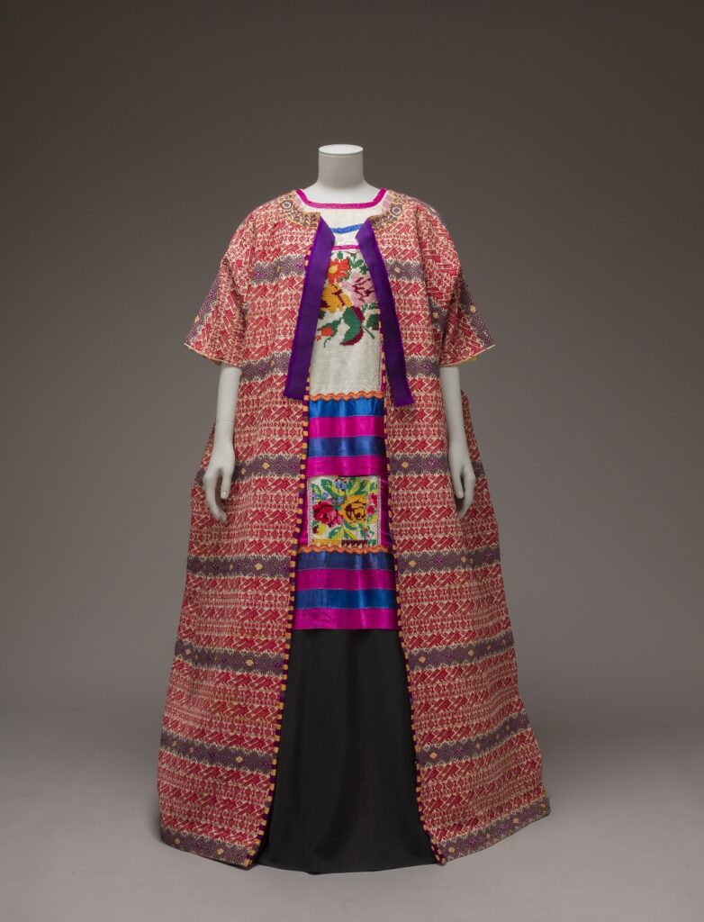 A Guatemalan-cotton coat and a hand-embroidered Mazatec huipil with satin ribbons. © Museo Frida Kahlo-Casa Azul collection. Photo: Javier Hinojosa, 2017