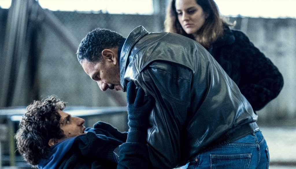 Confrontation between Abel (Louis Garrel) and Michel (Roschdy Zem), while Clémence (Noémie Merlant) looks on, in Garrel’s new film, L’Innocent.