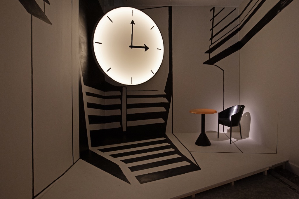 Exhibition view of "Paris Is Pataphysical,” at the Musée Carnavalet, with a mock-up of the Café Costes clock and staircase and furniture designed by Philippe Starck. © Gautier Deblonde