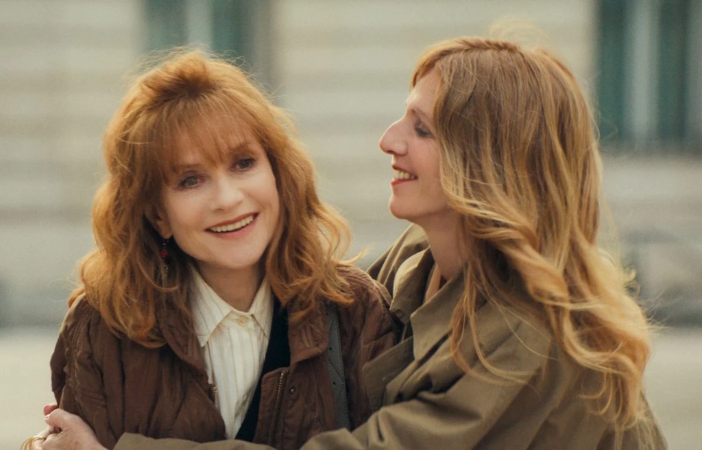 Corinne (Isabelle Huppert) gets a hug from Sandrine Kiberlain, playing herself in Ni Vue ni Connue.