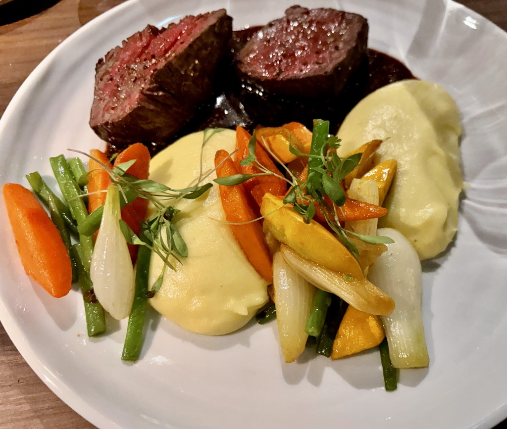 Beef tenderloin with vegetables and mashed potatoes.